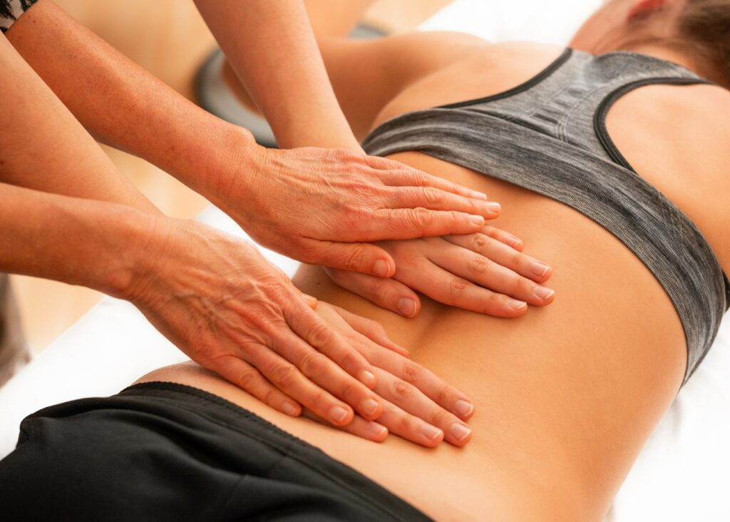 What is Osteopathy? Image depicts osteopathic mobilizations of tissue on low back of a patient.